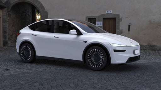 White electric car parked on a cobblestone street with a building in the background