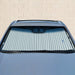 Manual retractable windshield sunshade extended in vehicle