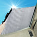 Manual retractable windshield sunshade being opened